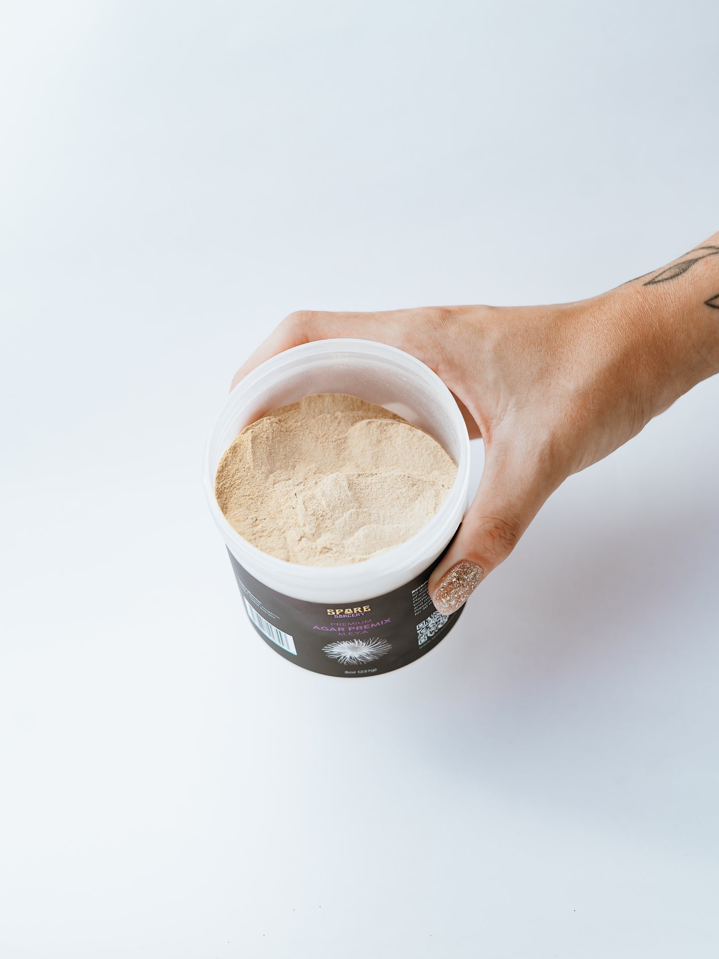 A Hand Holding Spore Sorcery Meya Mix